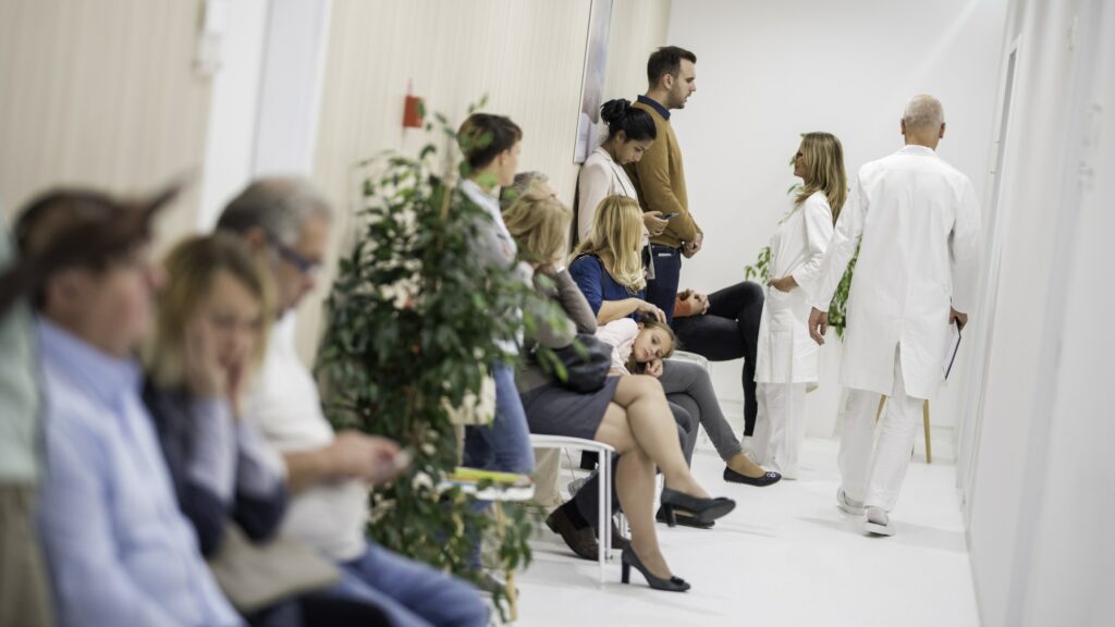 Group of people waiting in emergency room hallway